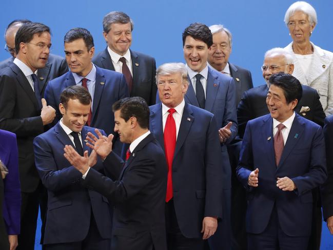 President Donald Trump and other heads of state react to Mexico's President Enrique Pena Nieto, throwing his hands up, being the last one to arrive for the family photo at the G20 summit, Friday, Nov. 30, 2018 in Buenos Aires, Argentina. (AP Photo/Pablo Martinez Monsivais)