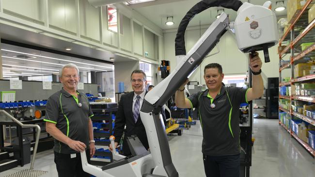 Peter Rowland managing director Micro-X, Charlie Hicks Carestream business director and Derek Rogers production manager a DRX Revolution Nano mobile x-ray machine. Picture: Brenton Edwards/AAP.