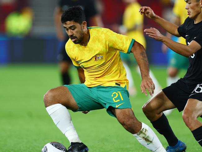 BRENTFORD, ENGLAND - OCTOBER 17: Massimo Luongo of Australia is challenged by Eliah Just of New Zealand during the Trans-Tasman Trophy international friendly match between Australia Subway Socceroos and New Zealand All Whites at Gtech Community Stadium on October 17, 2023 in Brentford, England. (Photo by Bryn Lennon/Getty Images)