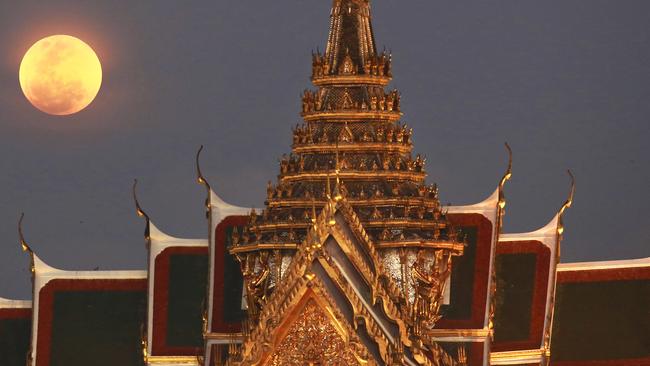 A full moon rises beside the Grand Palace in Bangkok. Picture: AP