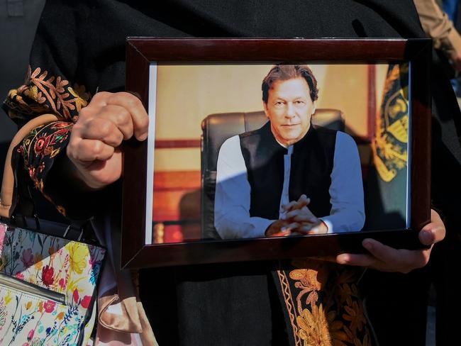 Senator and Pakistan Tehreek-e-Insaf (PTI) party's leader Falak Naz Chitrali, holds a portrait of jailed Pakistan's former Prime Minister Imran Khan, whose chances of a comeback are “limited”. Picture: AFP