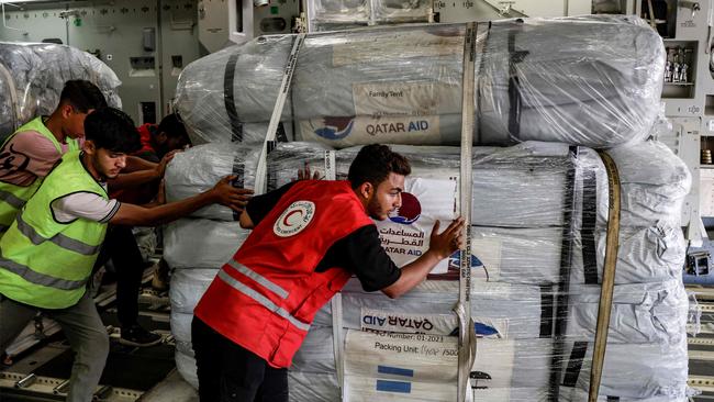 An Egyptian Red Crescent members unload a shipment of humanitarian aid bound for the Gaza Strip off a Qatar Emiri air force C-17 Globemaster III military transport aircraft. Picture: AFP