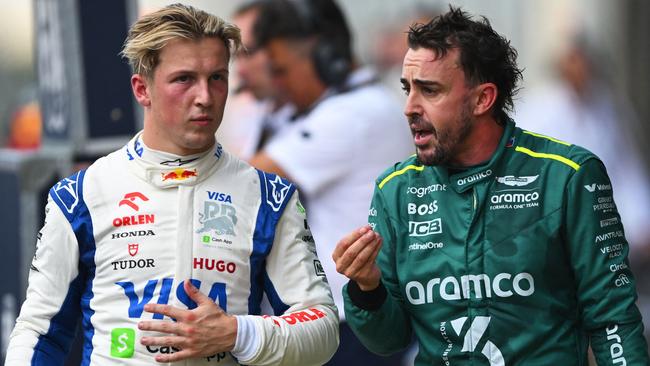 AUSTIN, TEXAS - OCTOBER 19: 16th placed Liam Lawson of New Zealand and Visa Cash App RB and 18th placed Fernando Alonso of Spain and Aston Martin F1 Team talk in parc ferme during the Sprint ahead of the F1 Grand Prix of United States at Circuit of The Americas on October 19, 2024 in Austin, Texas.   Rudy Carezzevoli/Getty Images/AFP (Photo by Rudy Carezzevoli / GETTY IMAGES NORTH AMERICA / Getty Images via AFP)