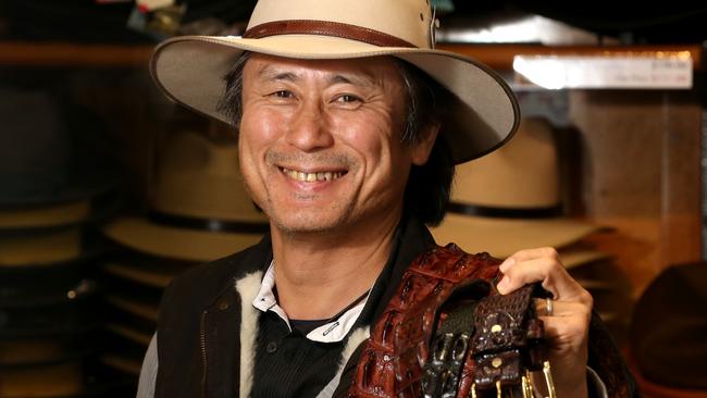 Owner of Quality Aussie Bush Hats and Oilskins at the Cairns Night Markets, Yatsuki Hirakawa with some croc skin belts PICTURE: ANNA ROGERS