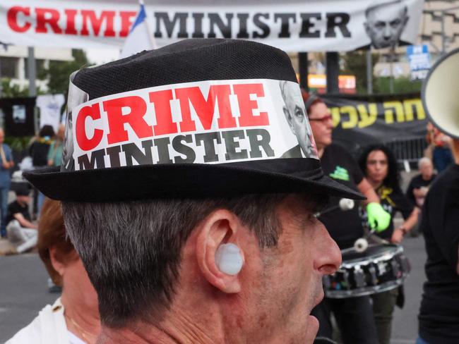 An Israeli protester wearing a hat with a slogan against Israeli Prime Minister Benjamin Netanyahu during an anti-government demonstration in Tel Aviv. Picture: AFP
