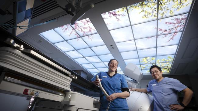 Radiation Therapists Jen McNickle and Alton Ma with the new linear accelerator at the RHH. Picture Chris Kidd