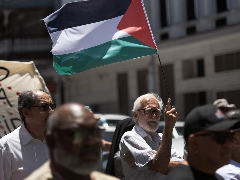 A man holds a Palestinian flag as they take part in a pro-Palestinian demonstration outside the High Court in Cape Town. Picture: AFP