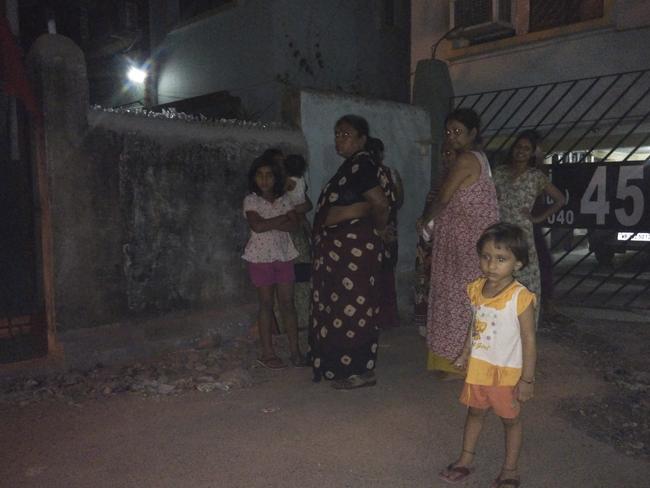 Strong earthquake ... Residents who rushed outdoors following tremors stand on a road outside their houses in Kolkata, India. Picture: AP.