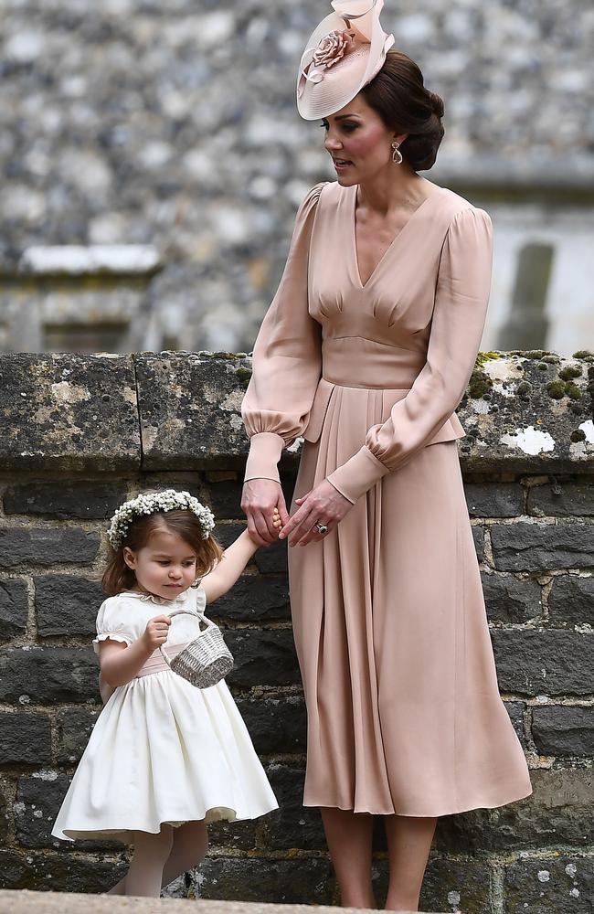 The duchess waits patiently with her daughter following Pippa’s ceremony.