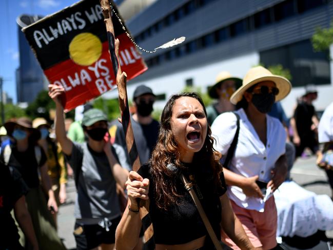 Protesters take part in an Invasion Day march through central Brisbane. Picture: NCA NewsWire / Dan Peled