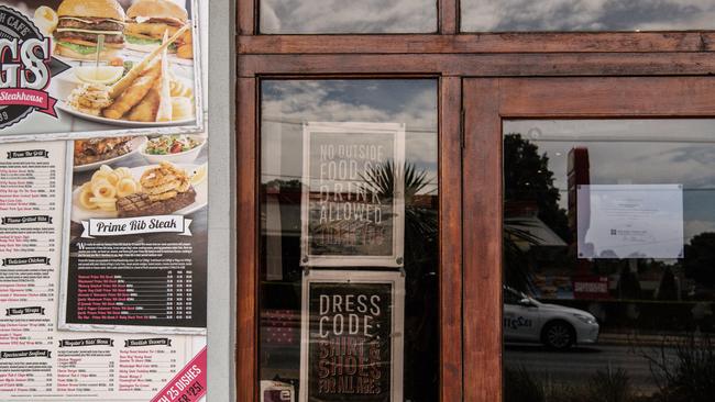 Liquidation notices can be seen on the front doors of Hog's Breath Steakhouse in Holden Hill in March.