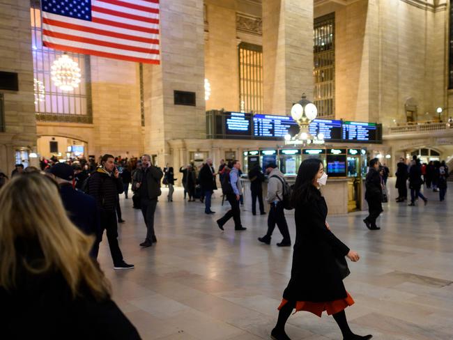 A woman wears a mask as she walks through Grand Central station during peak hour in Manhattan. Picture: AFP