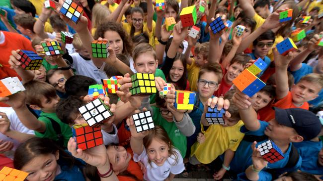 Hungarian pupils pose with Rubik's Cubes during a flashmob to celebrate the 50th anniversary of Hungarian architect Erno Rubik’s invention. Picture: Ferenc Isza/AFP