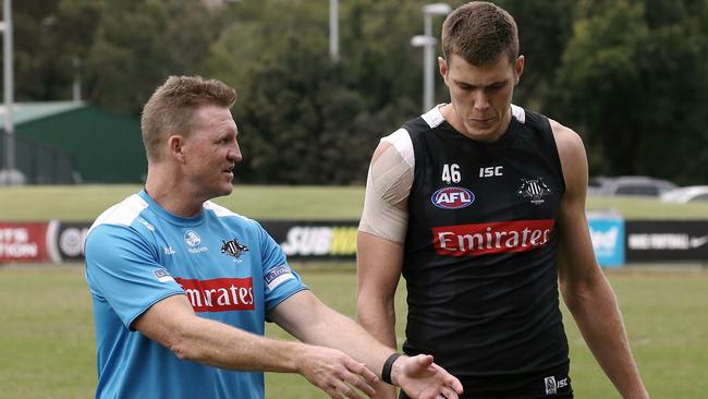 Nathan Buckley shows Cox some of the finer points of the game. Picture: Wayne Ludbey