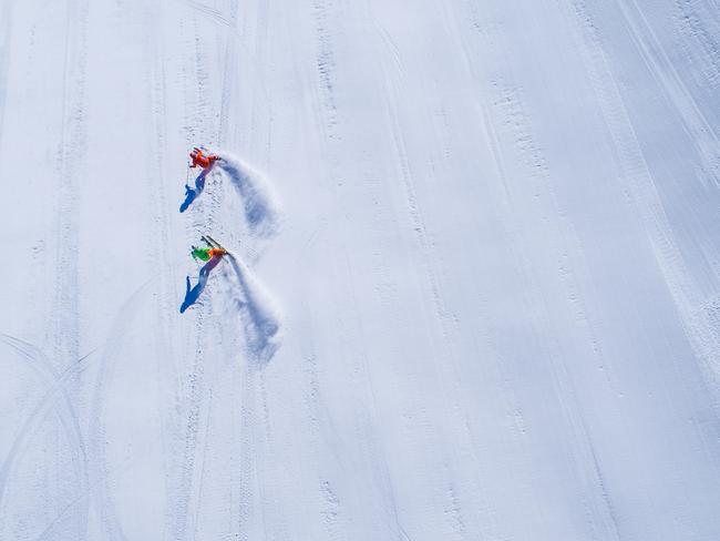 Two skiers on an empty ski-slope from a drones perspective, Austria. Picture: Supplied