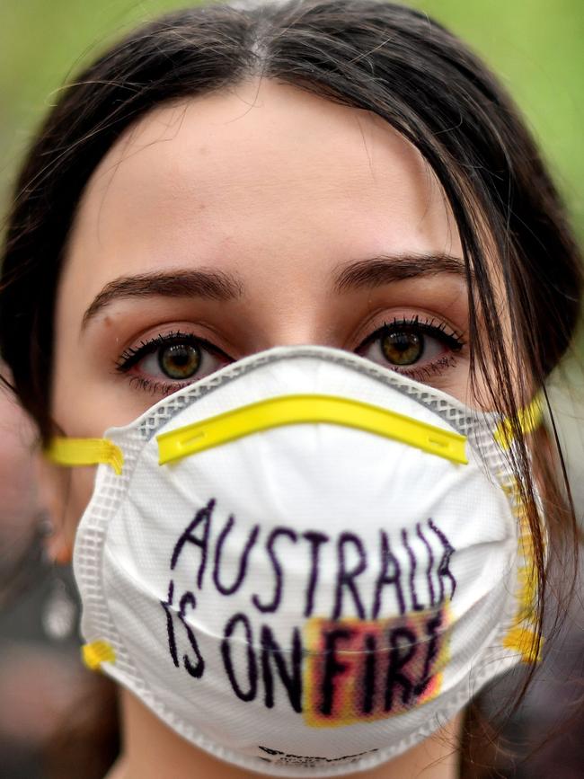 A demonstrator with a mask attends a climate protest rally in Sydney. Picture: AFP