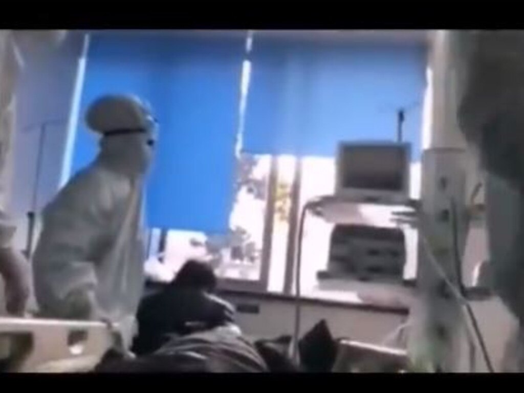 In this still from the same video, doctors work on a patient while corpses in body bags lie unattended nearby. Picture: Radio Free China