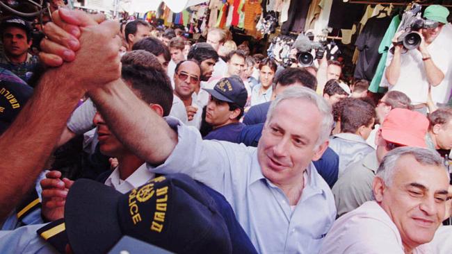 Israel’s Prime Minister Benjamin Netanyahu shakes the hand of a supporter while on a campaign-stop at Tel Aviv's Carmel Market May 14, 1996. Picture: Nati Harnik