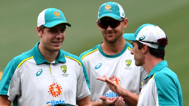 Australia's Cameron Green (L) receives his Baggy Green cap from teammate Pat Cummins (R). Picture: AFP