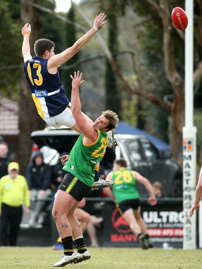 EFL: Beaconsfield’s Harrison Coe leaps high over Bryce Galvin of Bayswater. Picture: Hamish Blair