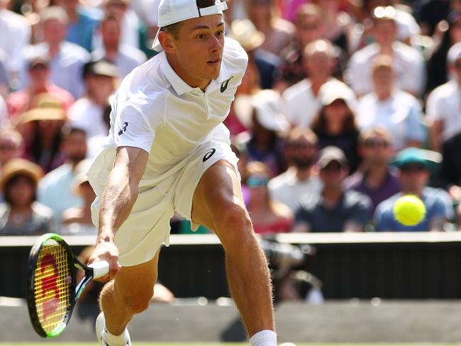 LONDON, ENGLAND - JULY 07:  Alex De Minaur of Australia returns a shot against Rafael Nadal of Spain during their Men's Singles third round match on day six of the Wimbledon Lawn Tennis Championships at All England Lawn Tennis and Croquet Club on July 7, 2018 in London, England.  (Photo by Clive Brunskill/Getty Images)