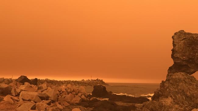 An orange, hazy sky over Narooma in NSW on Saturday. Picture: AAP