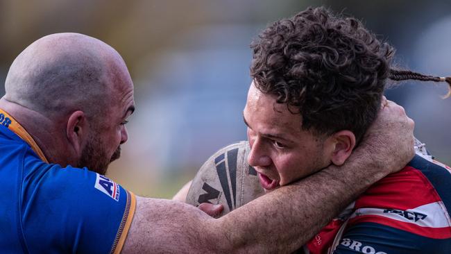 Hatrick hero Kienan Tempest battles with Kangaroos fullback Shannon Gallant. News Local, Pictures by Julian Andrews.