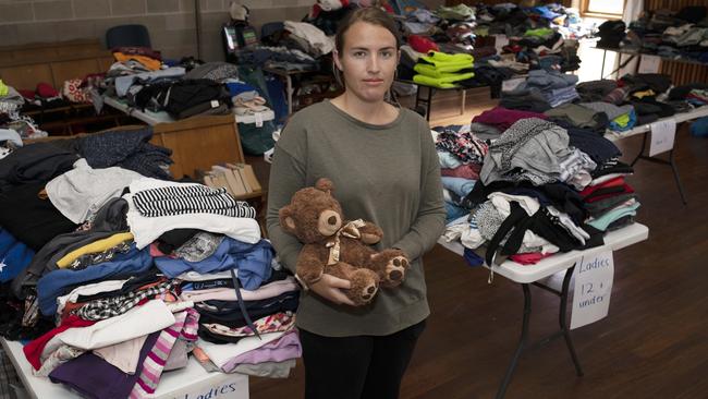 Macgillivray local Georgia Weatherspoon along with other members of the community have gathered clothing, personal items and children’s toys at the Parndana community hall for people in need. Picture: AAP / Emma Brasier