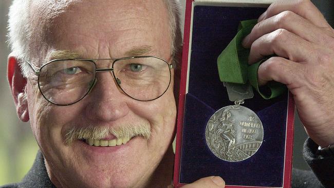 Peter Norman with his silver medal he won at the 1968 Mexico Olympics in 2000.