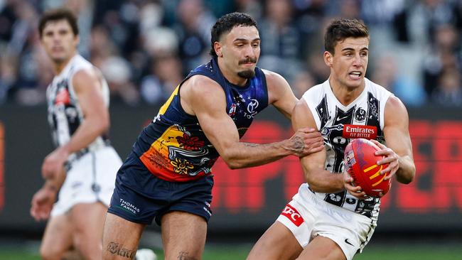 MELBOURNE, AUSTRALIA - MAY 18: Nick Daicos of the Magpies is tackled by Izak Rankine of the Crows during the 2024 AFL Round 10 match between The Collingwood Magpies and Kuwarna (Adelaide Crows) at The Melbourne Cricket Ground on May 18, 2024 in Melbourne, Australia. (Photo by Dylan Burns/AFL Photos via Getty Images)