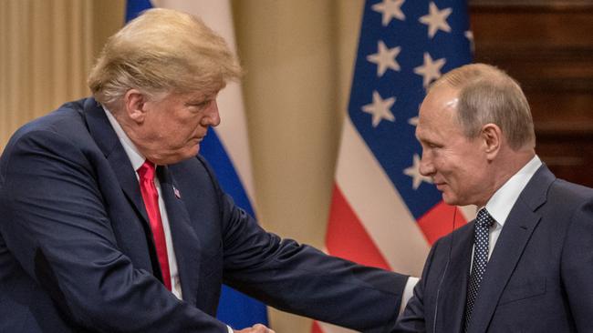 Donald Trump and Vladimir Putin shake hands during a joint press conference after their summit in Helsinki. Picture: Getty Images.