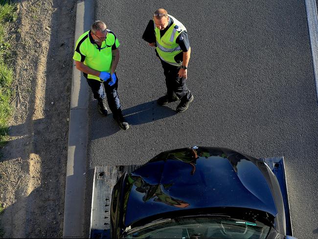 A BMW believed to have been used in a hit-run in Mitcham is removed from EastLink. Picture: Mark Stewart