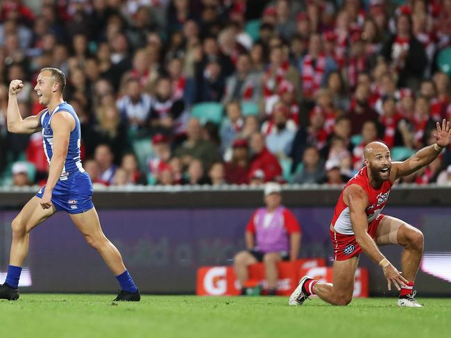 SYDNEY, AUSTRALIA - MAY 05:  Billy Hartung of the Kangaroos celebrates kicking a goal as Jarrad McVeigh of the Swans appeals for a touch during the round seven AFL match between the Sydney Swans and the North Melbourne Kangaroos at Sydney Cricket Ground on May 5, 2018 in Sydney, Australia.  (Photo by Mark Metcalfe/Getty Images)