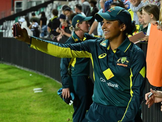 MACKAY, AUSTRALIA - SEPTEMBER 22: Alana King of Australia takes a selfie with Megan Schutt and fans during game two of the Women's T20 International Series between Australia and New Zealand at Great Barrier Reef Arena on September 22, 2024 in Mackay, Australia. (Photo by Albert Perez/Getty Images)