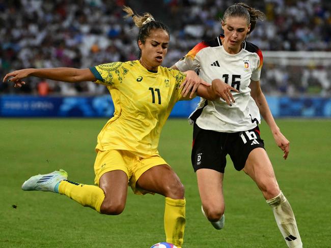 Australia's forward #11 Mary Fowler is marked by Germany's midfielder #16 Jule Brand during the women's group B football match between Germany and Australia during the Paris 2024 Olympic Games at the Marseille Stadium in Marseille on July 25, 2024. (Photo by Christophe SIMON / AFP)