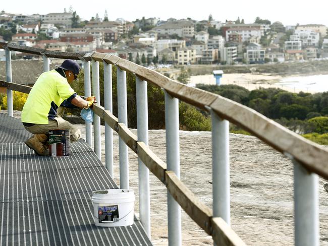 Workers put the finishing touches on the new walkway from Malabar to South Maroubra. Picture: John Appleyard