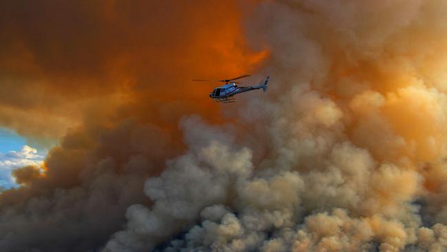 Firefighters and helicopter crews keep a close watch. Picture: Graham Reibelt