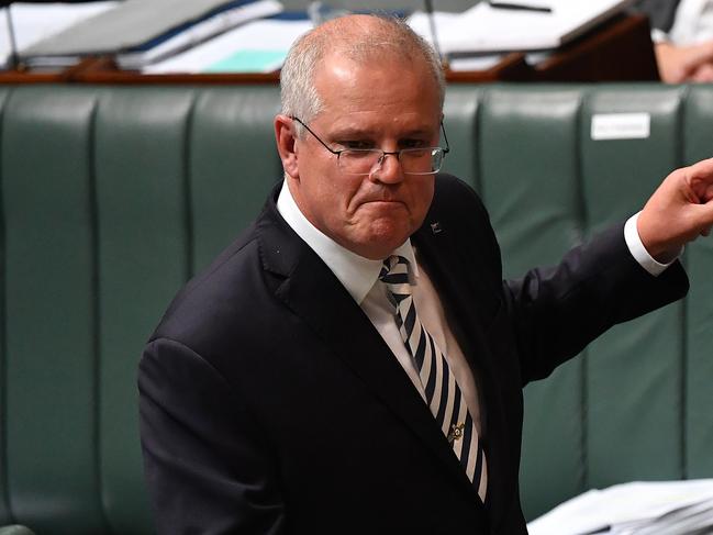 CANBERRA, AUSTRALIA - MARCH 25: Prime Minister Scott Morrison reacts to Leader of the Opposition Anthony Albanese during Question Time in the House of Representatives at Parliament House on March 25, 2021 in Canberra, Australia. The federal government was on Monday set back by new allegationsÃÂ broadcastÃÂ by the Ten Network after pixelated images of unnamed Coalition advisers allegedly engaging in performing lewd sex acts on the desks of female MPs resulting in a Morrison staff member being sacked last night. Additionally, the ABC Network aired a first hand account by an Australian Parliament security guard of what she witnessed on the night Brittany Higgins was allegedly raped in the office of then-defence industry minister Linda Reynolds in early 2019. (Photo by Sam Mooy/Getty Images)