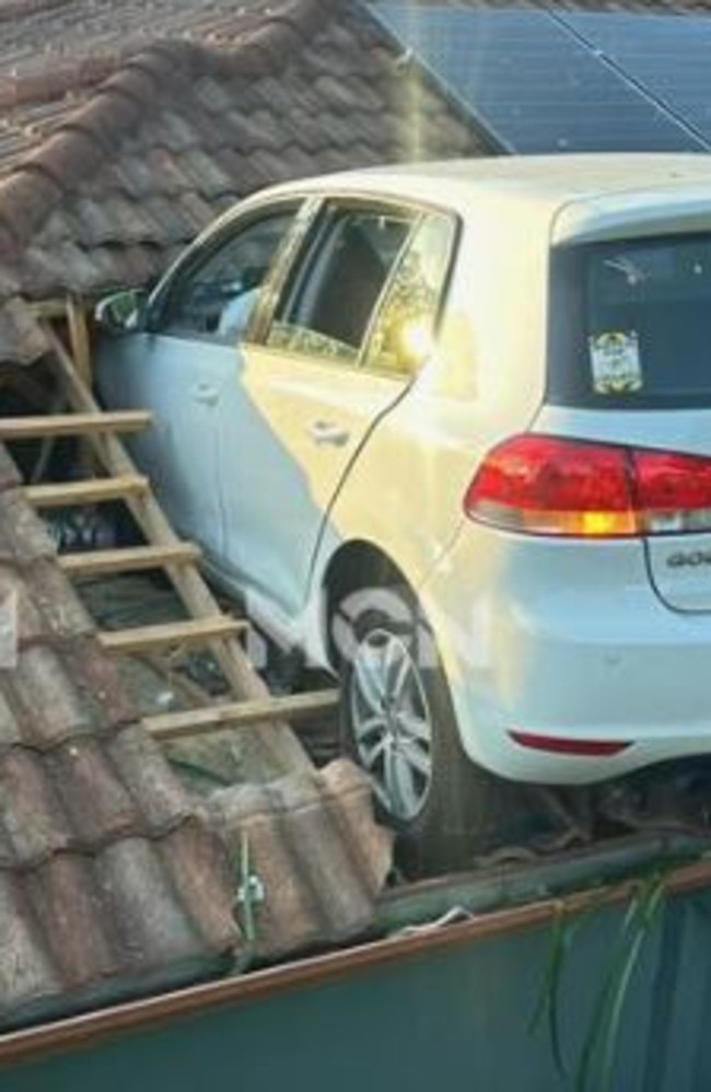 The vehicle wedged in the roof of the home.