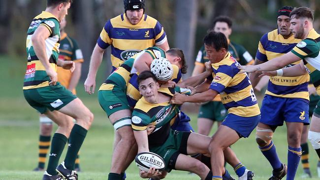 Gold Coast District Rugby Union match between Gold Coast Eagles and Surfers Paradise at James Overell Park. Surfers Paradise scrumhalf James Crisp offloads under pressure from Eagles player Shoma Okubo. Picture: Richard Gosling