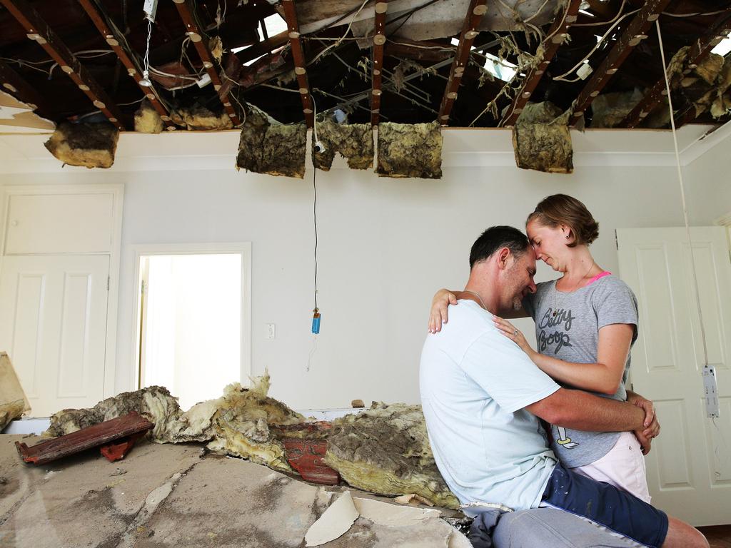 Natalie and Paul Hennessy clean up in December 2015 after a tornado hit the southern Sydney suburb of Kurnell. Picture: Braden Fastier