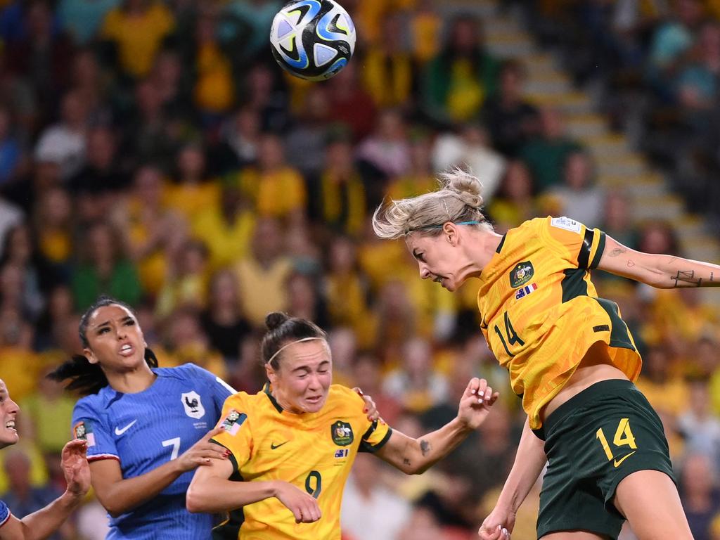 Alanna Kennedy with one of her 17 clearances against France. Picture: FRANCK FIFE / AFP