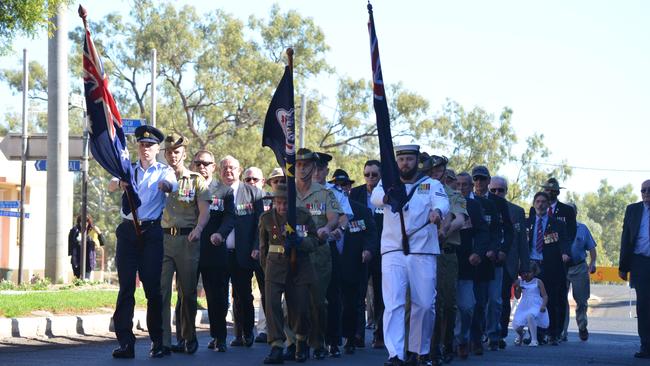 OUR HEROES: Current, returned and ex-service personnel marching during the Charleville Anzac Day service, led by Lawson Alick, Henry Maris and Glen Brassington. 2014.