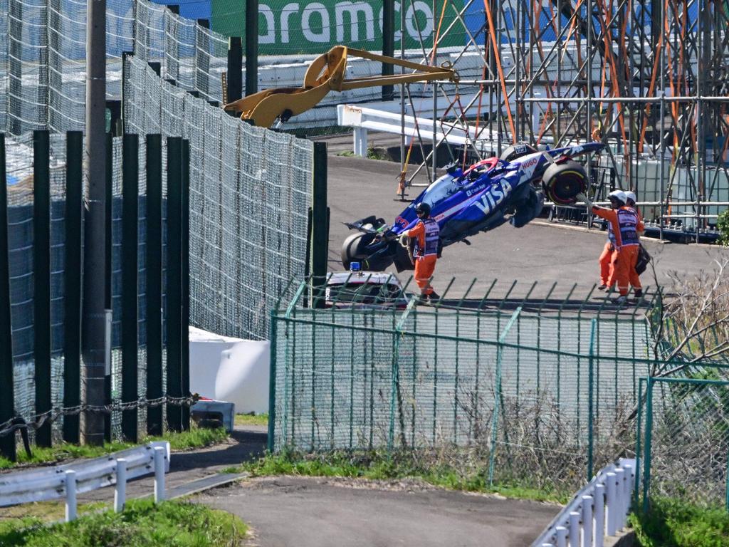 Ricciardo’s car is removed from the track after he crashed out at the start of the Formula One Japanese Grand Prix. Picture: AFP