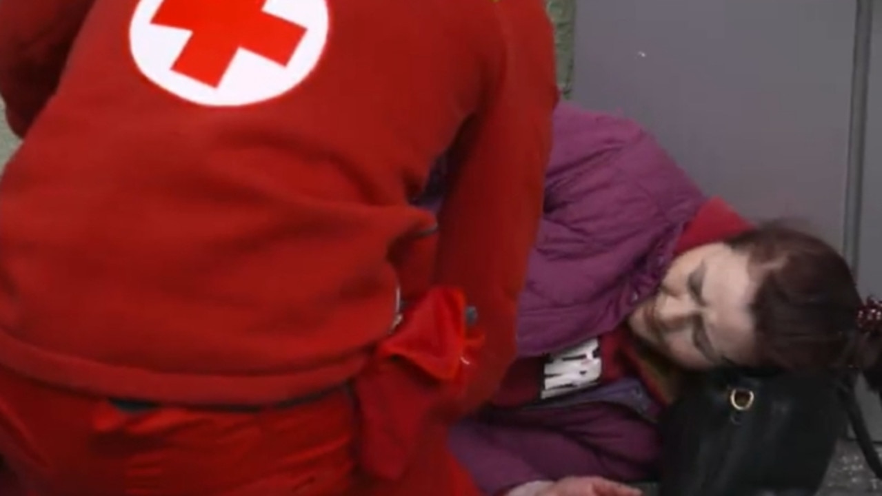 A Ukrainian woman receives treatment from a Red Cross crew member after the missile strike. Picture: Screengrab ABC News