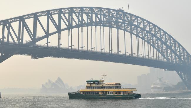 The Sydney Harbour Bridge and Opera House are shrouded on Tuesday. Picture: AAP