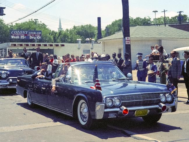 Nashville, Tennessee - May 18, 1963: Vintage nikon film scan of a photograph of President John F. Kennedy arriving for a campaign visit to Nashville's Vanderbilt University's Dudley Field on May 18, 1963 in the same 1961 Lincoln Continental convertible  that he was assassinated in six months later in Dallas.