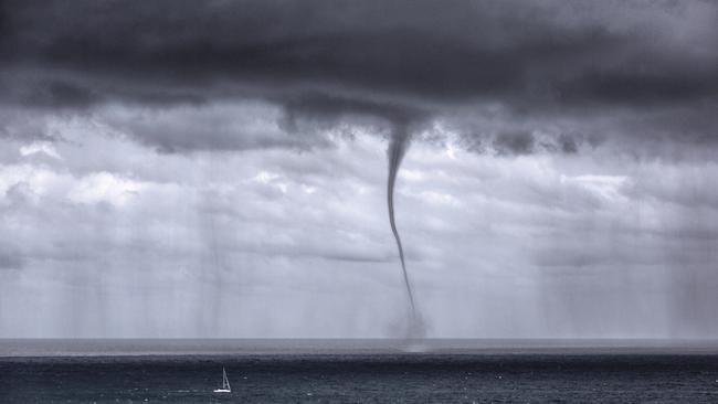 Mona Vale photographic artist Pamela Pauline's extraordinary image of a water spout, which formed off Mona Vale Headland, dwarfing a yacht. The picture was chosen for the 2021 Bureau of Meteorology Weather Calendar. Picture: Pamela Pauline