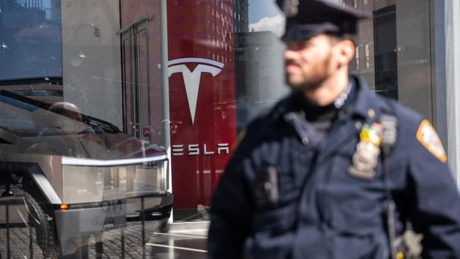 Police stand guard as protesters gather outside of a Manhattan Tesla dealership to demonstrate against Tesla CEO Elon Musk. Photo: Spencer Platt/Getty Images/AFP