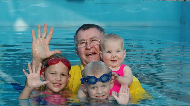 Laurie Lawrence with the Waller family, Jess 7yrs, Jake 3yrs, and Lauren 9mths at the Mudgeeraba Pool. Picture: PaulRiley.